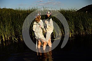 Girls in ethnic clothes with wreath of flowers celebrating