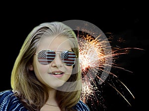 Girls face with 4th of July Fireworks lighting night sky