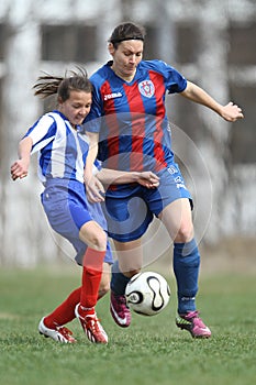 Girls fighting for ball during soccer game