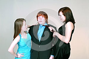 Girls fighting over blushing boy