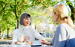 Girls friends drink coffee and enjoy talk. True friendship friendly close relations. Conversation of two women cafe