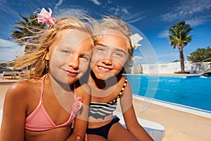 Girls friends enjoying summer at swimming pool