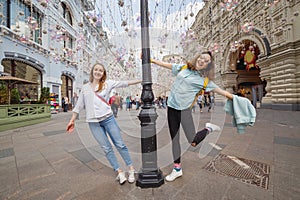 girls friends travelers having fun at the Arbat Street in Moscow