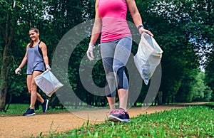 Girls with garbage bag doing plogging