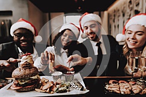 Girls and Guys. Burger. Santa`s Hat. Young People.