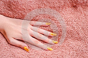 Girls hand with nailart on sweater