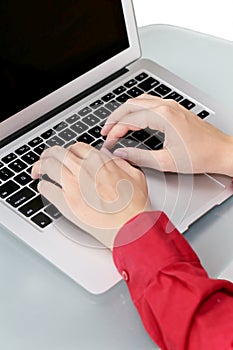Girls hands typing on laptop