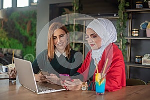 Girls hanging out and typing on laptop and relaxing