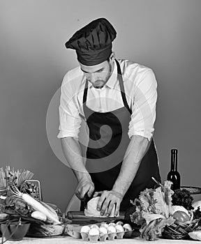 Girls with happy faces and stationery. Chef with busy face chops cabbage with knife on blue