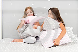 Girls happy friends with cute pillows. Pillow fight pajama party. Sleepover time for pillow fight. Doing whatever they