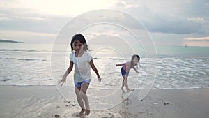 girls have fun and joy time at beautiful beach while running from joy