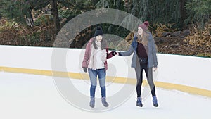 Girls have a lot of fun doing ice skating in New Yorks Central Park