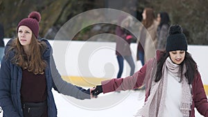 Girls have a lot of fun doing ice skating in New Yorks Central Park