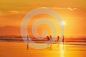 Girls having fun in the beach at sunset