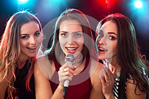 Girls having fun singing at a party