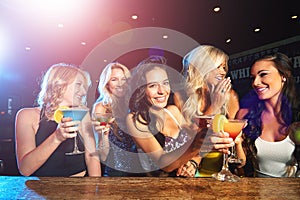 The girls are having fun tonight. young women drinking cocktails in a nightclub.
