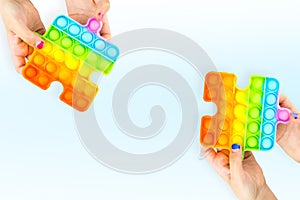 Girls holding Anti stress Popit toy isolated on the white background
