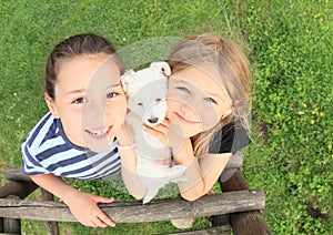 Girls holding a puppy