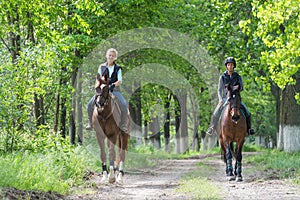 Girls on horseback riding photo