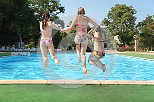 Girls jump in pool
