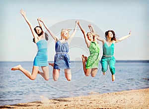 Girls jumping on the beach