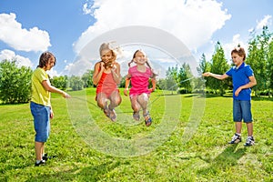 Girls jumping over the rope with friends