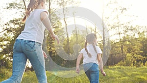 girls kid dream together run in the park at sunset. happy family people in the park concept. two sisters playing catch