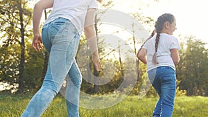 girls kid dream together run in the park at sunset. happy family people in the park concept. two sisters playing catch