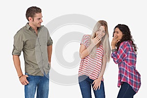 Girls laughing about secrets and leaving man out