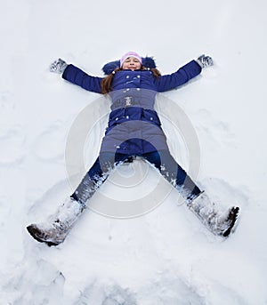 Girls laying in star shape in snow