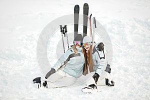 Girls posing against backdrop of mountains in ski gear.