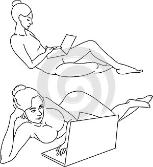 Girls lie behind a laptop