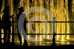 Girls looking at a colorfull fountain