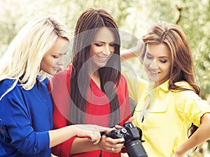 Girls looking at photos on a camera