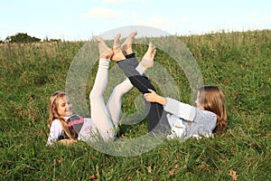 Girls lying in grass