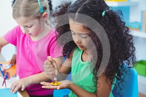 Girls making arts and crafts together photo