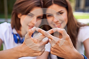 Girls making infinity symbol