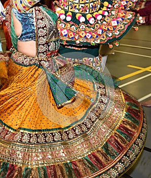 Girls, Man, women are performing garba and dandiya dance wearing traditional Indian folk dress during Navratri festival,Canada