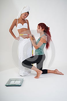 Girls measuring the waistline