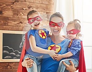 Girls and mom in Superhero costumes