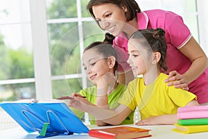 Girls and mother doing homework