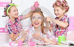 Girls with mother in hair curlers