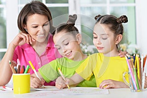 Girls with mother on lesson of art