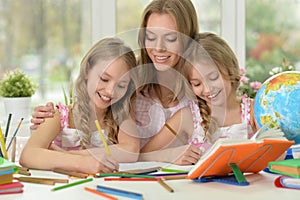 Girls with mother on lesson of art