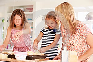 Girls With Mother Making Cheese On Toast