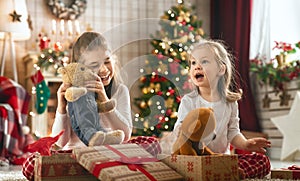 Girls opening Christmas gifts