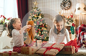 Girls opening Christmas gifts