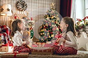 Girls opening Christmas gifts