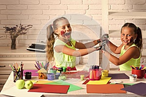 Girls painters painting with gouache paints on table