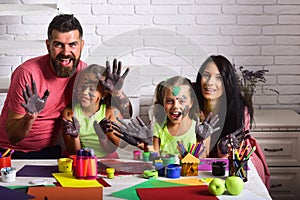 Girls painters painting with mother and father